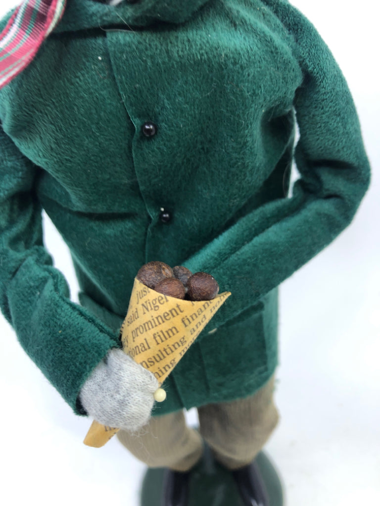 BYERS' CHOICE MAN IN GREEN COAT HOLDING NUTS-1993.