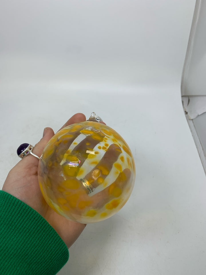 BLOWN GLASS CLEAR W/ YELLOW SPECKS ORNAMENT.