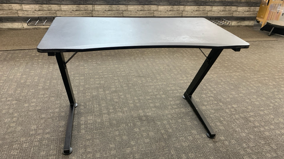 BLACK PLASTIC GAMING DESK W/ANGLED METAL LEGS.