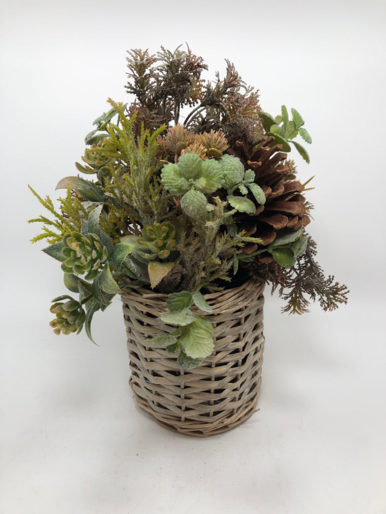 FAUX GREENERY ARRANGEMENT W/PINECONES IN WICKER VASE.