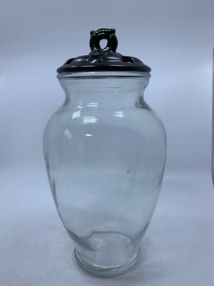 LARGE GLASS VASE WITH BLACK PIERCED LID.