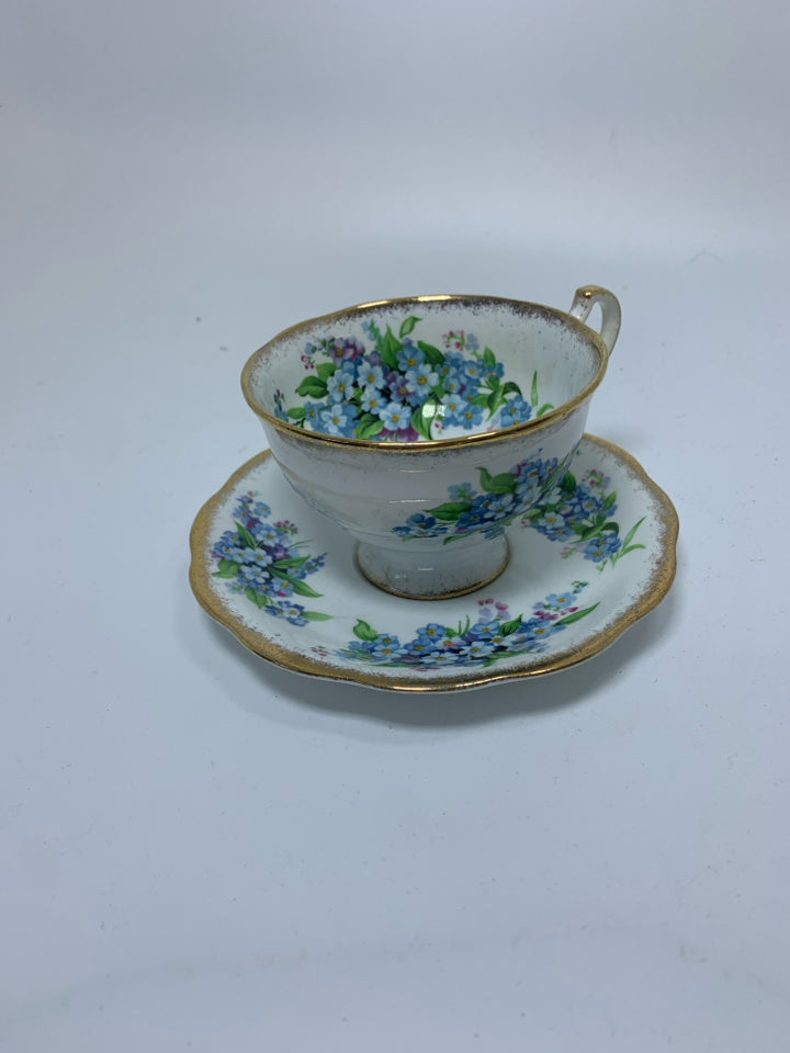 LIGHT BLUE SMALL FLOWERS W/ GOLD RIM.