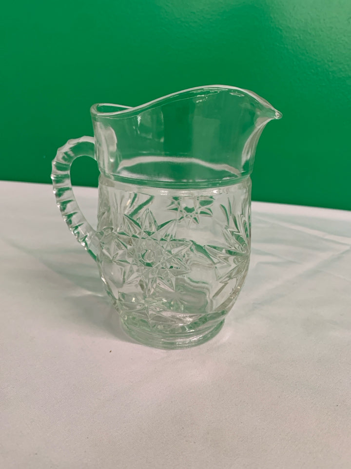 HEAVY CUT GLASS STAR PATTERN PITCHER.