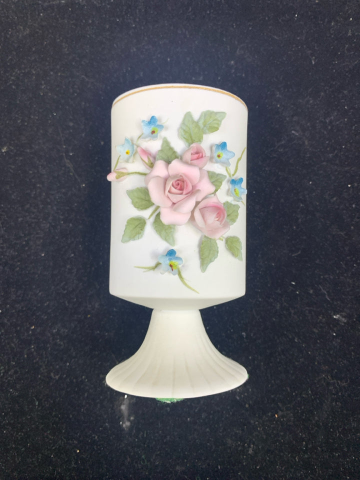 VTG WHITE FOOTED VASE W/ EMBOSSED PINK+BLUE FLOWERS.