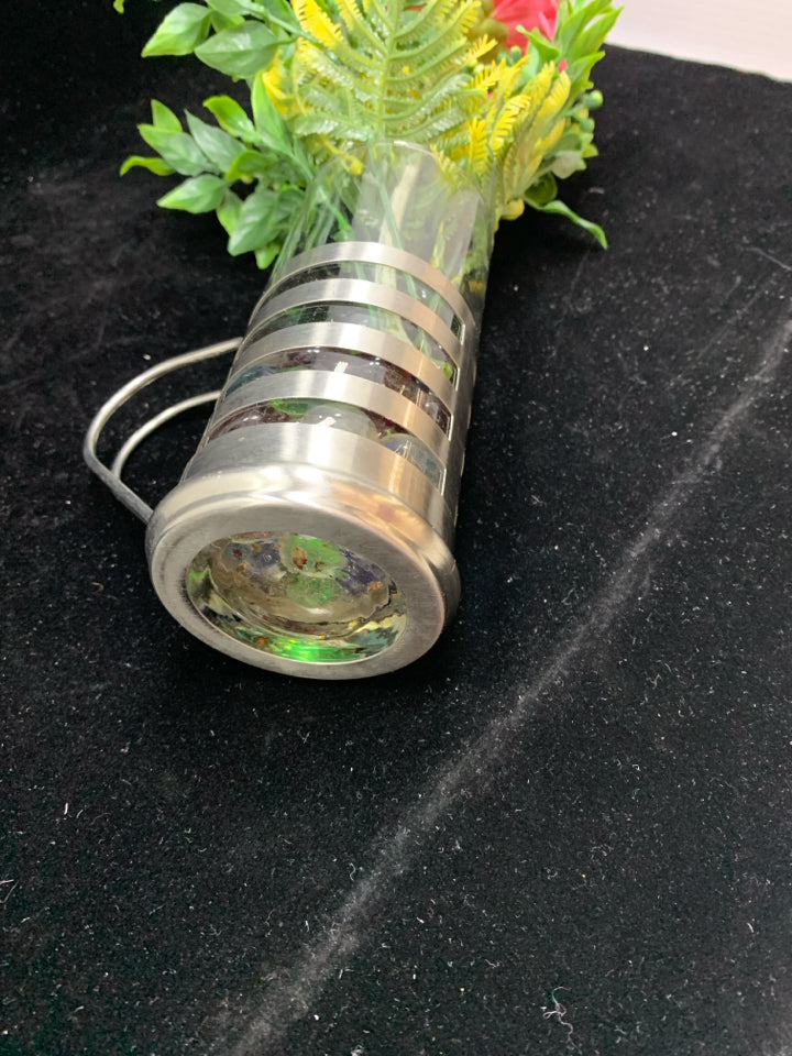 FAUX CARNATION IN GLASS AND SILVER MUG W/MARBLES.