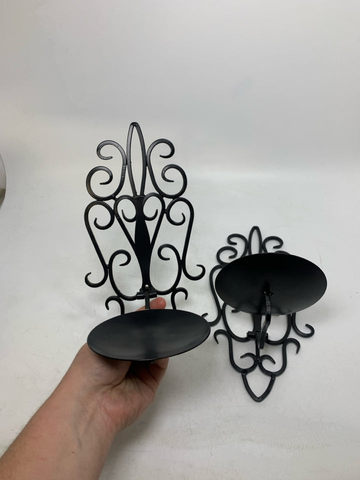 2 BLACK SCROLL FOLD DOWN PILLAR CANDLE HOLDERS.