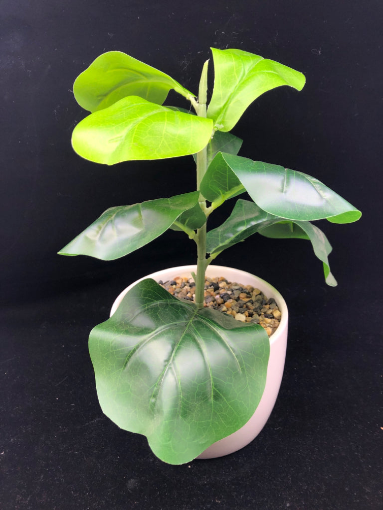 FAUX GREEN LEAVES IN WHITE PLANTER.