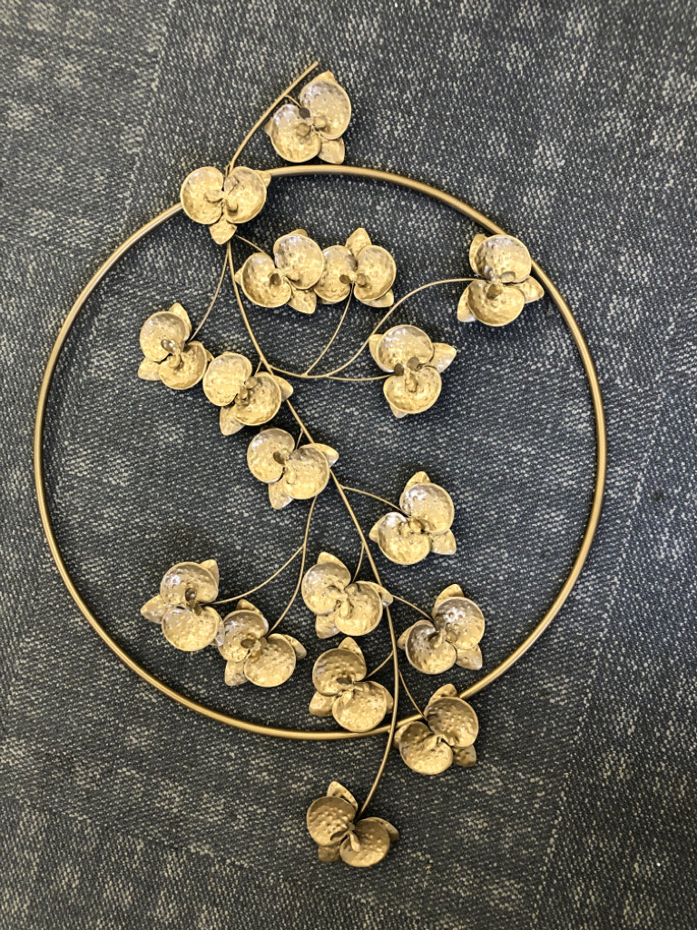 GOLD CIRCLE WITH FLORAL WALL HANGING.