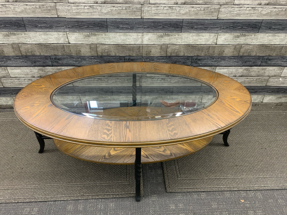 OVAL WOOD W GLASS TOP AND BOTTOM STORAGE COFFEE TABLE.