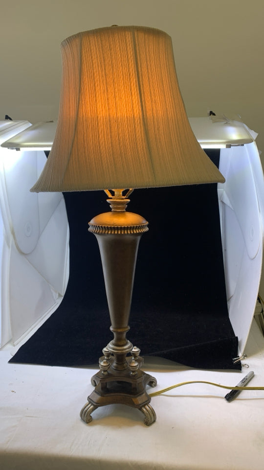BRONZE BASE TABLE LAMP W/TAN TEXTURED STRIPE SHADE.