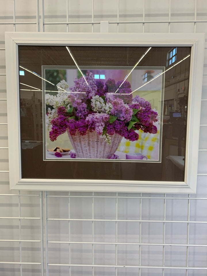 LILACS IN WHITE BASKET IN WHITE FRAME.