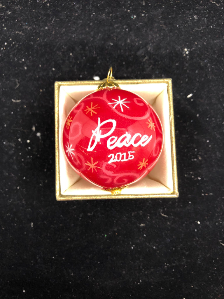 PIER 1 RED PEACE SPHERE ORNAMENT IN GREEN BOX.