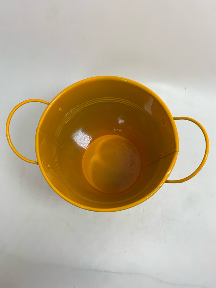 ORANGE METAL BUCKET.