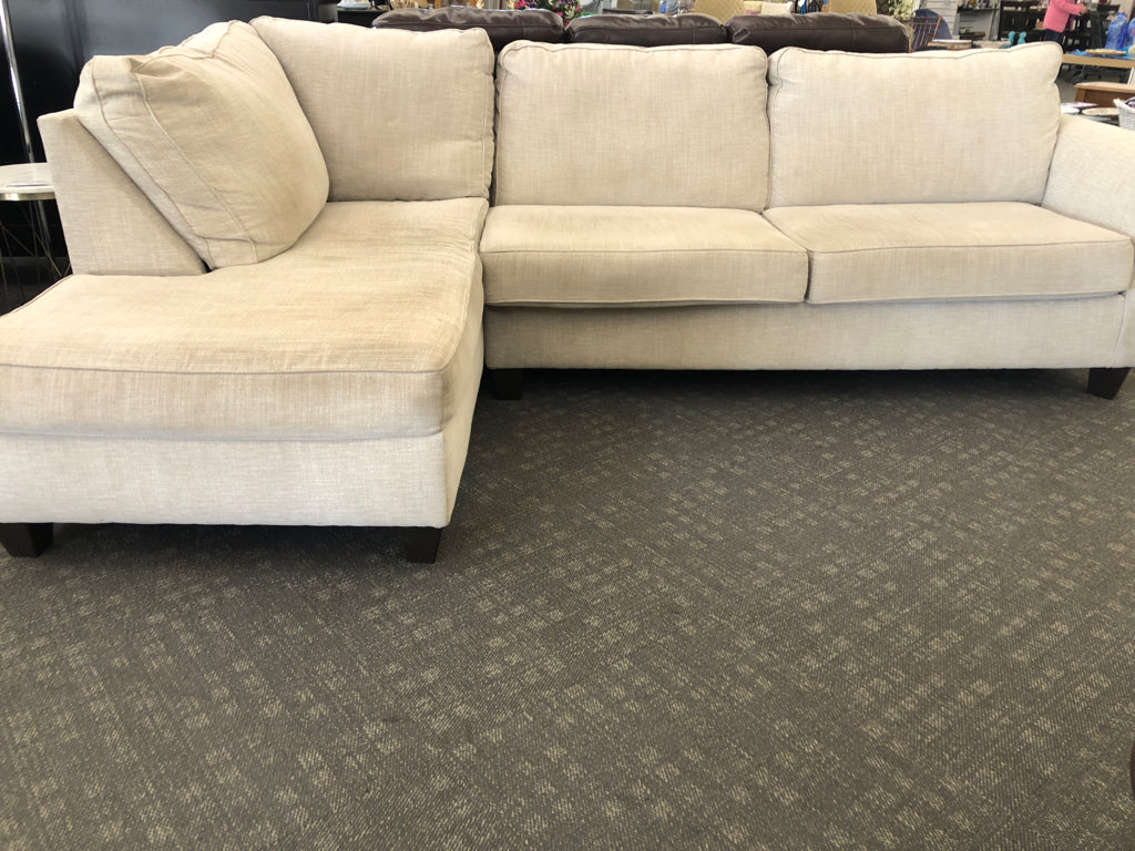 L-SHAPED CREAM COUCH.