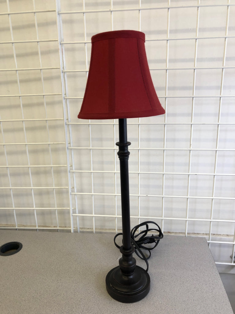SKINNY BLACK BASE LAMP W/ RED SHADE.