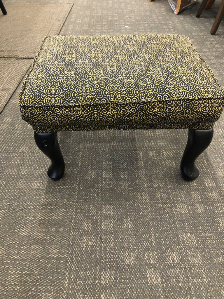 BLACK AND GOLD SCROLL PATTERN OTTOMAN.