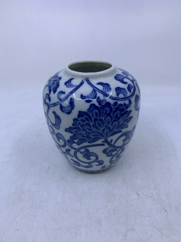 WHITE W/ BLUE FLORAL CERAMIC VASE.