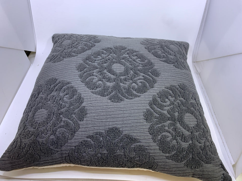 DARK GREY PILLOW W/ EMBOSSED MEDALLION DESIGN.