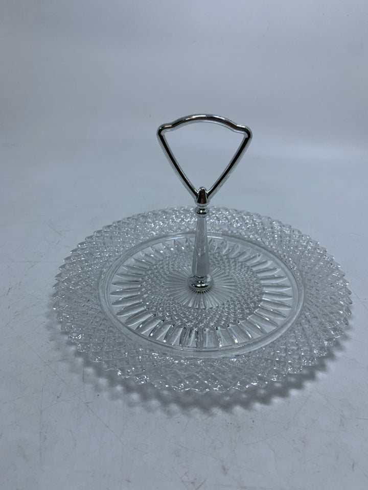 GLASS PLATE W/ METAL HANDLE IN CENTER.