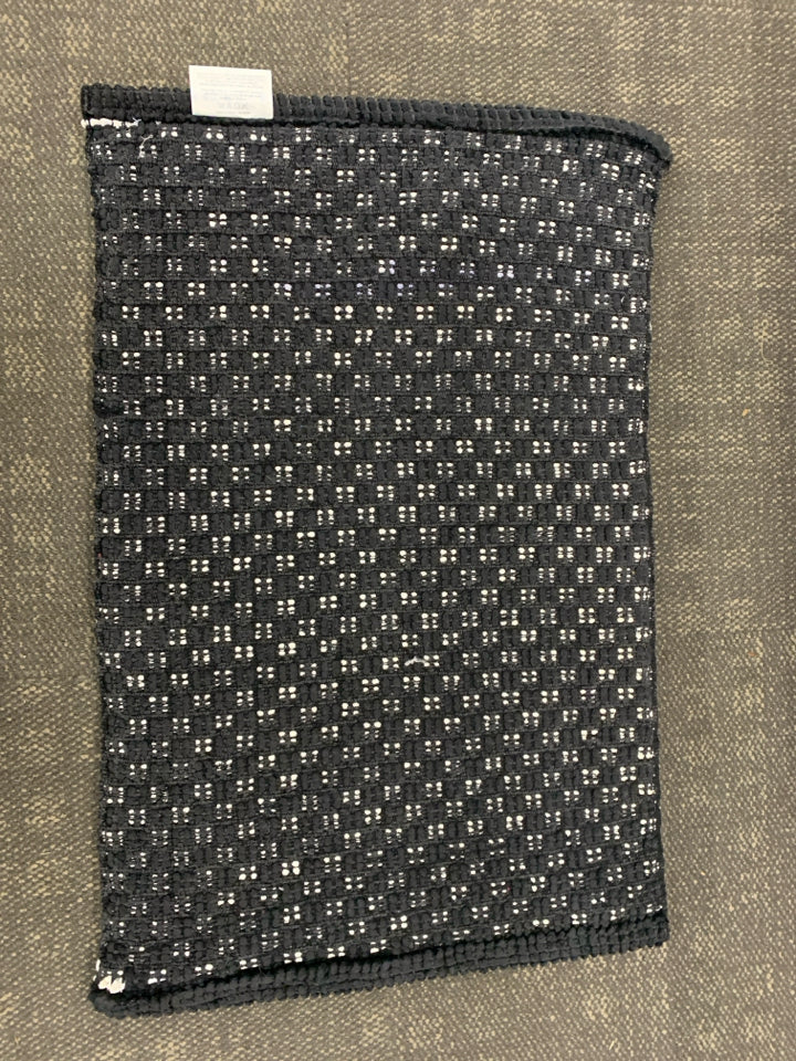 B&W CHECKERED RUG.