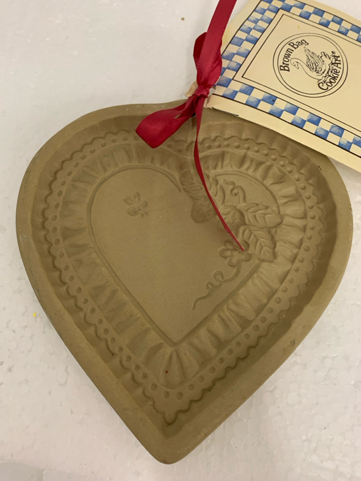 HEART SHAPED STONEWARE COOKIE PRESS BROWN BAG.