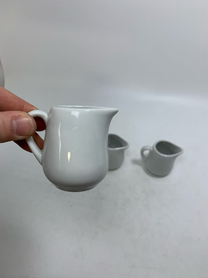 4 MINI WHITE PORCELAIN PERSONAL CREAMERS.