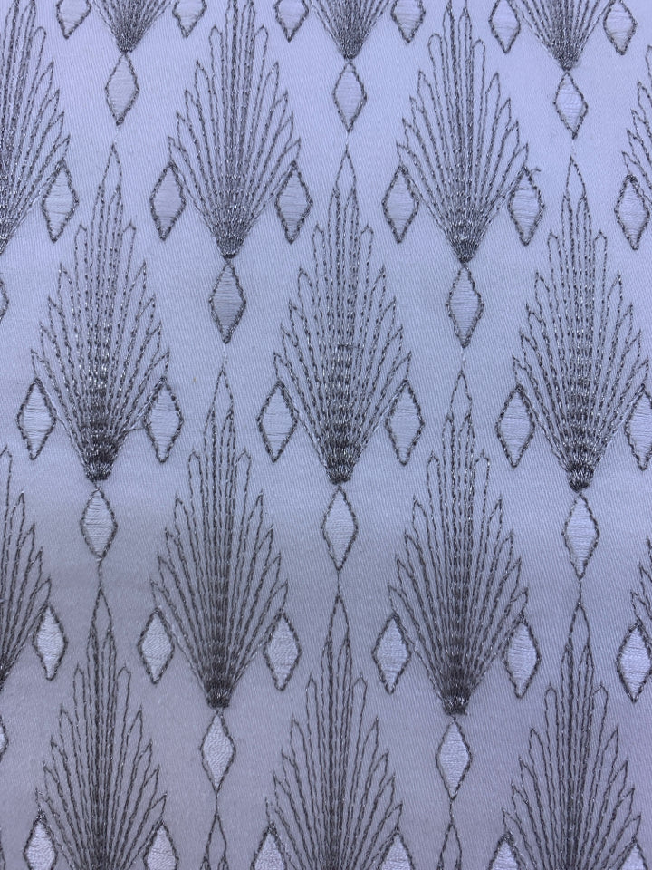 WHITE AND SILVER PATTERN PILLOW.