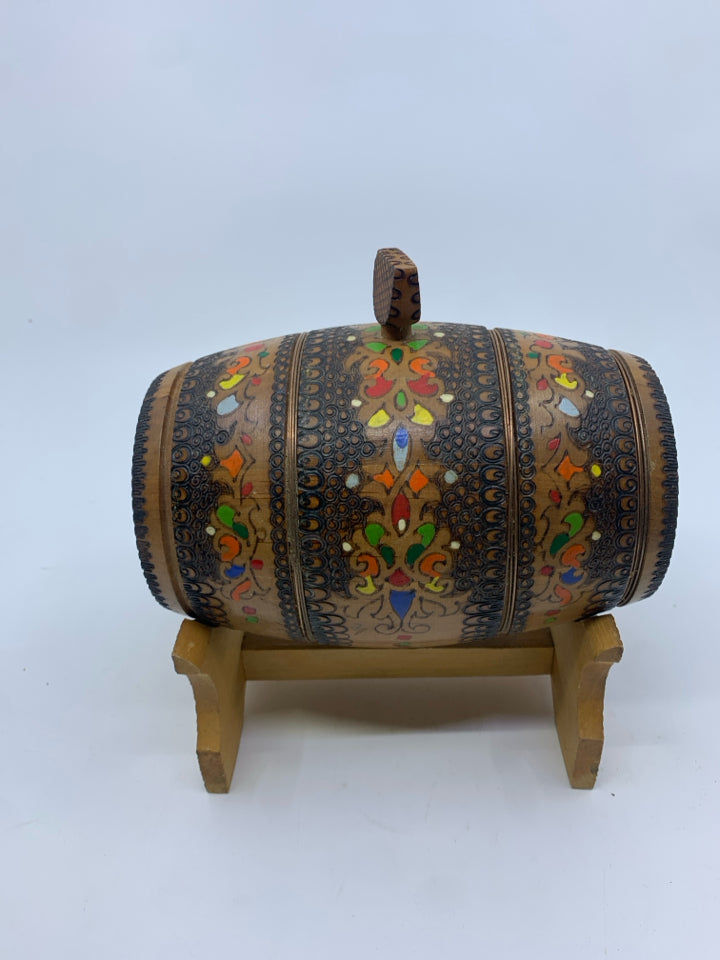 DECORATIVE CARVED/MULTI COLORED WOOD BARREL ON STAND.