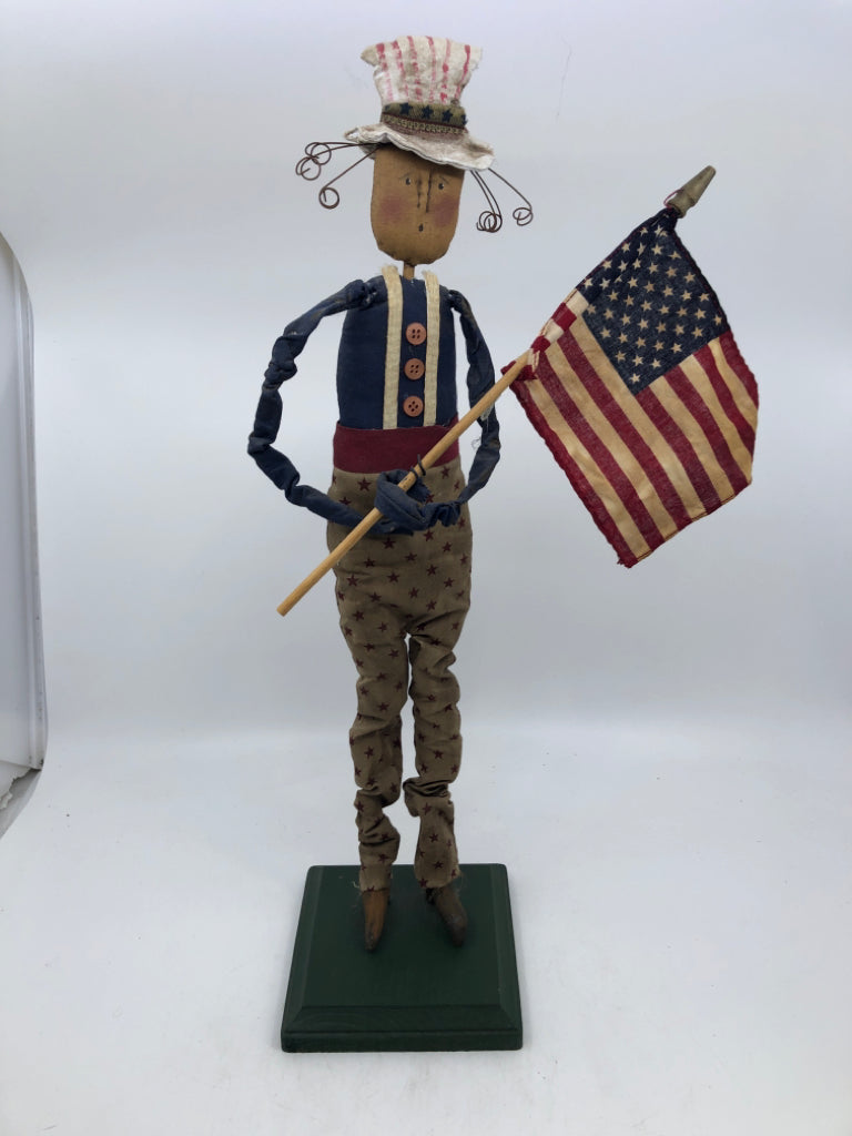 PRIMITIVE MAN HOLDING FLAG.