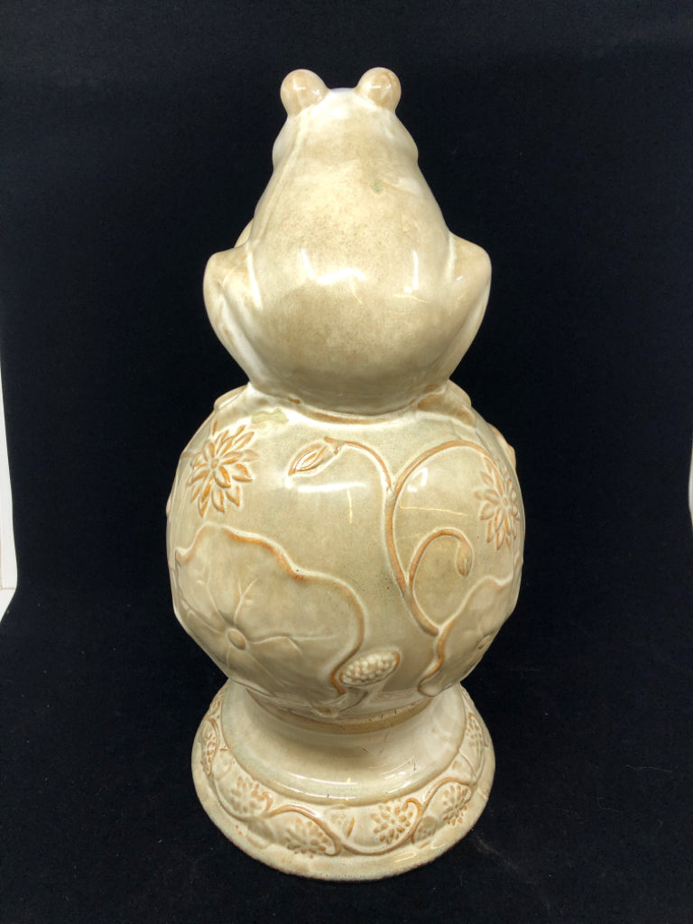 CREAM CERAMIC FROG ON SPHERE W/FLOWER DESIGN.