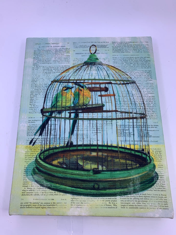GREEN BIRD CAGE OVER NEWSPAPER PRINT WALL CANVAS.