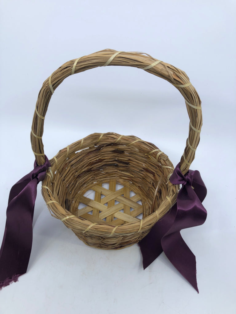 WICKER BASKET W/HANDLE AND PURPLE RIBBONS.