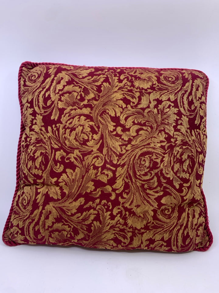 RED W/GOLD FLORAL ACCENT PILLOW.