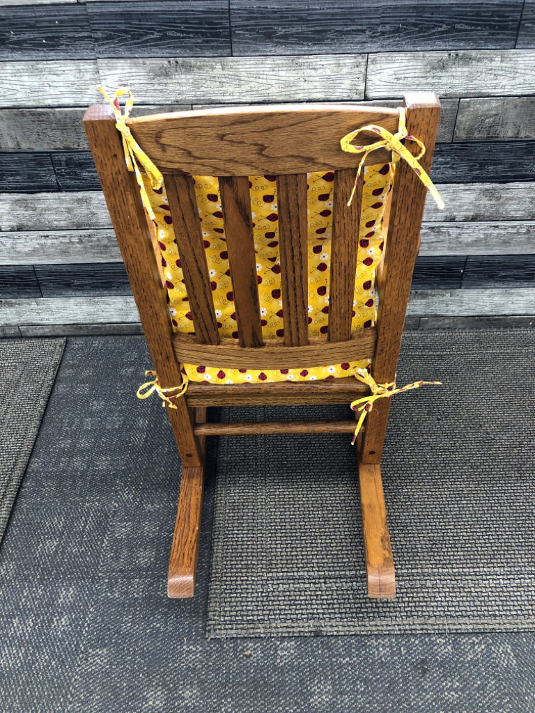 VTG KIDS WOOD ROCKING CHAIR W/LADYBUG CUSHIONS.