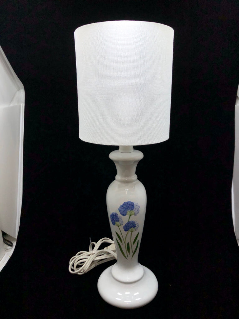 WHITE CERAMIC LAMP W/BLUE FLOWERS AND WHITE SHADE.