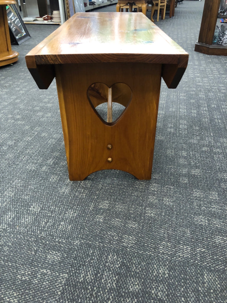 SMALL WOOD BENCH W/ HEART CUTOUTS.
