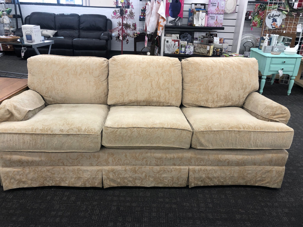 CREAM VELVET SOFA W/ EMBOSSED SCROLL DESIGN.