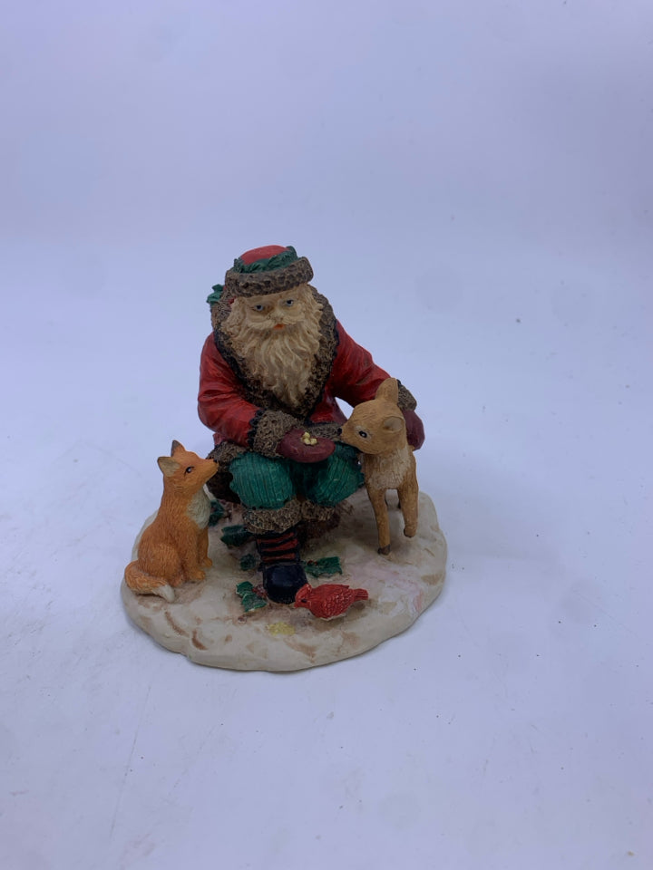 RESIN SANTA FEEDING WILDLIFE.