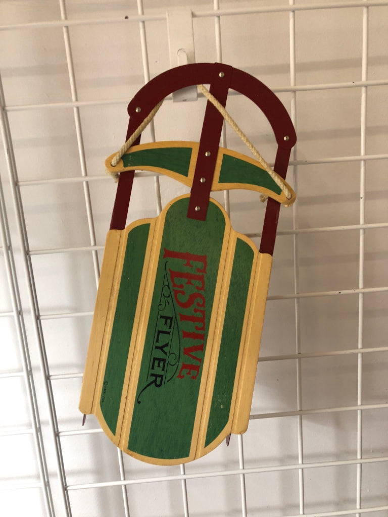 FESTIVE WOOD AND METAL SLED DECOR.