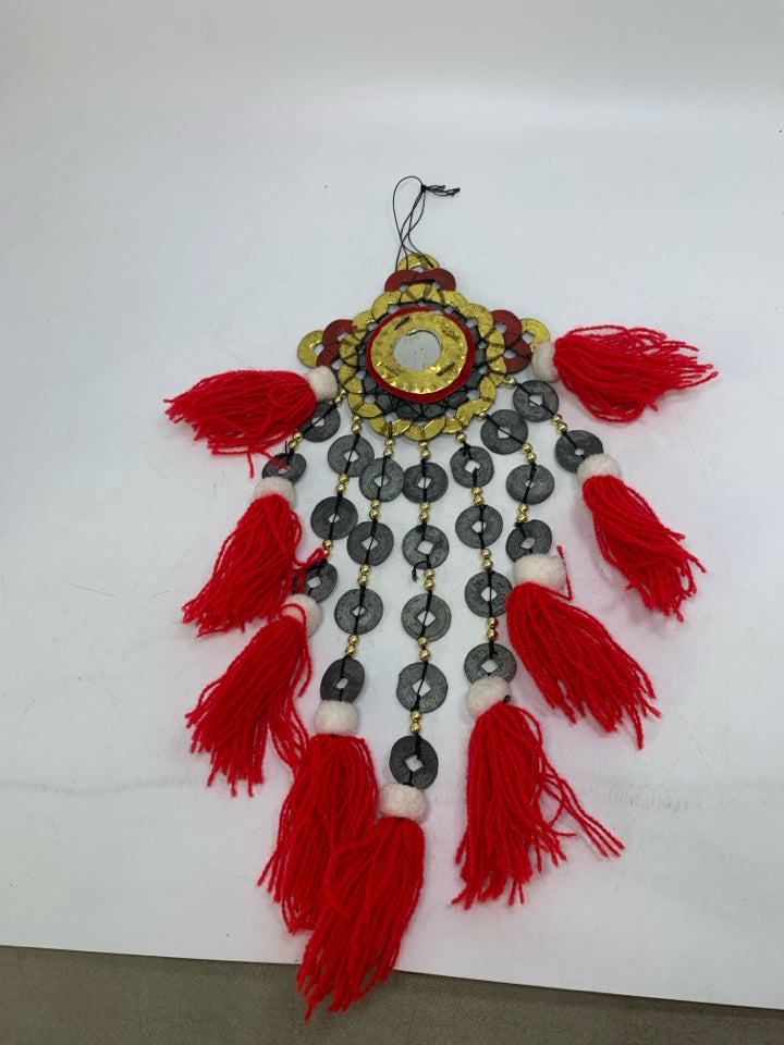 HANGING ABSTRACT METAL MEDALLIONS W/ RED TASSELS.