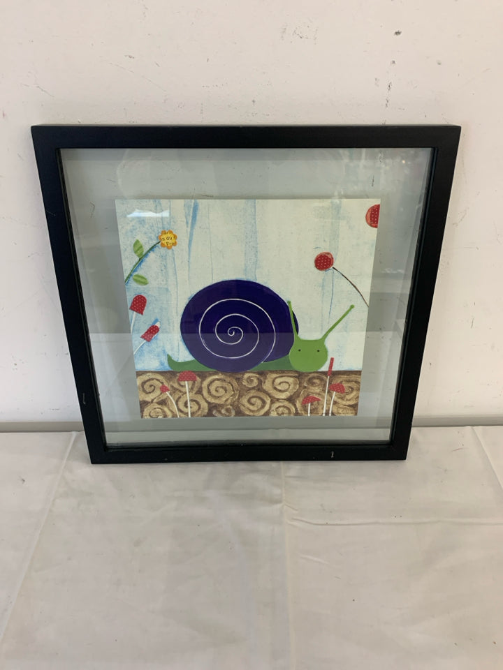 SNAIL IN BLACK FRAME WALL HANGING.