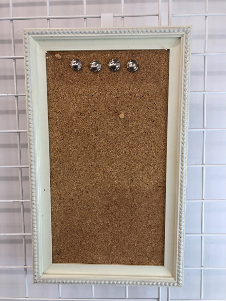 PIN BOARD W/PINS IN WHITE FRAME.
