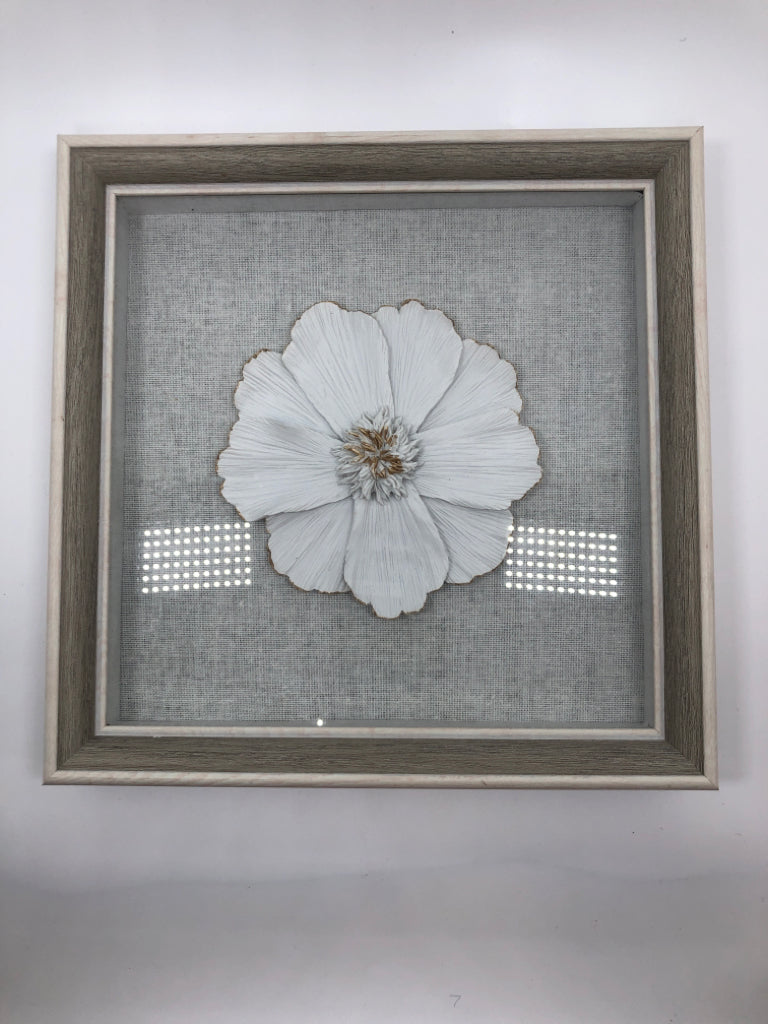 WHITE FLOWER INSIDE GREY SHADOWBOX.