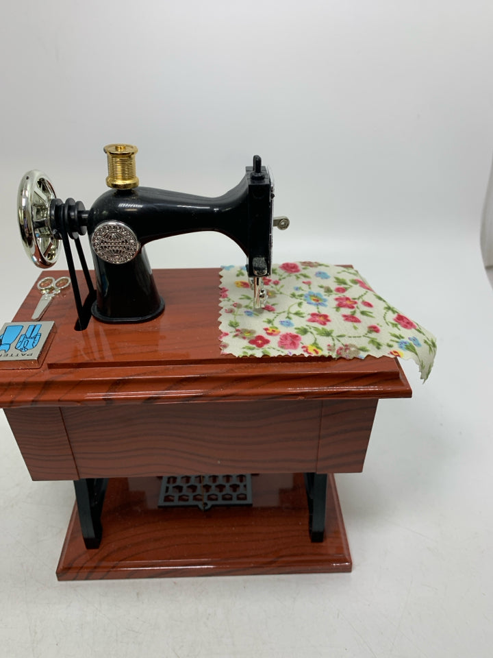 PLASTIC SEWING TABLE W/ MACHINE MUSIC BOX MOVING PIECES.