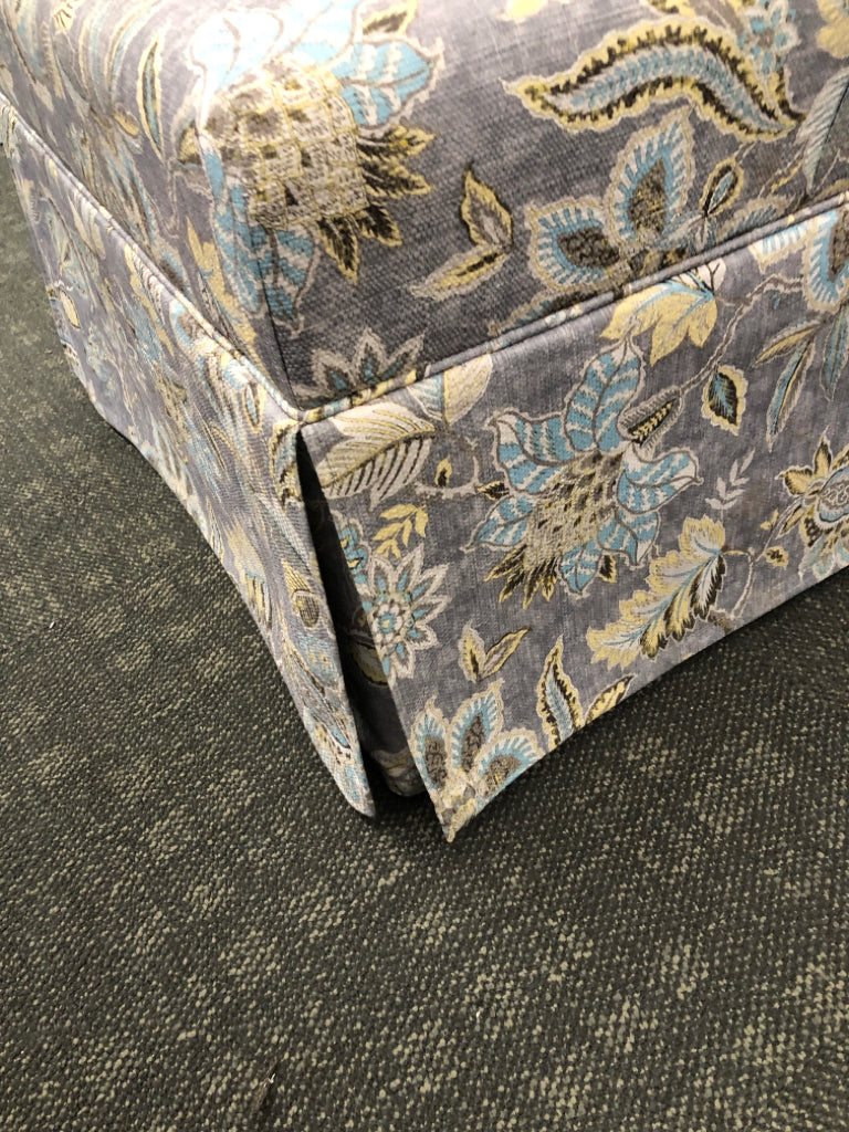 GREY FLORAL UPHOLSTERED OTTOMAN.