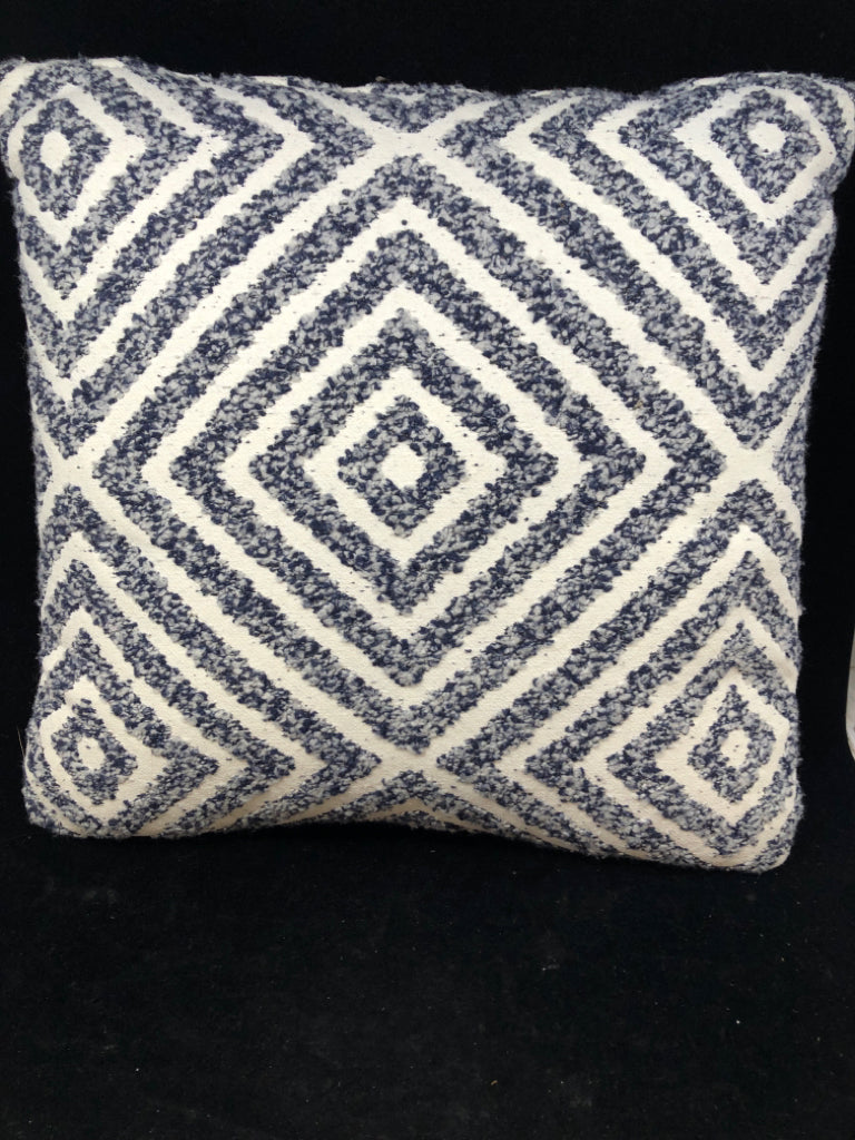 CREAM PILLOW W/BLUE TEXTURED DIAMOND DESIGN.