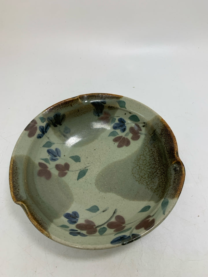 MULTI COLORED POTTERY BOWL W/ RED/BLUE FLOWERS UNEVEN EDGE.