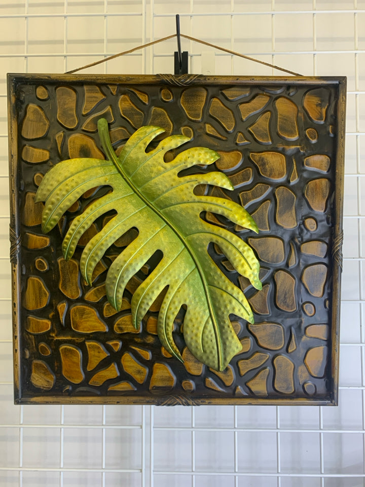 SQUARE BRONZE METAL W/PALM LEAF WALL HANGING.