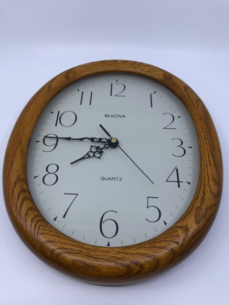 OVAL WOOD FRAME CLOCK.