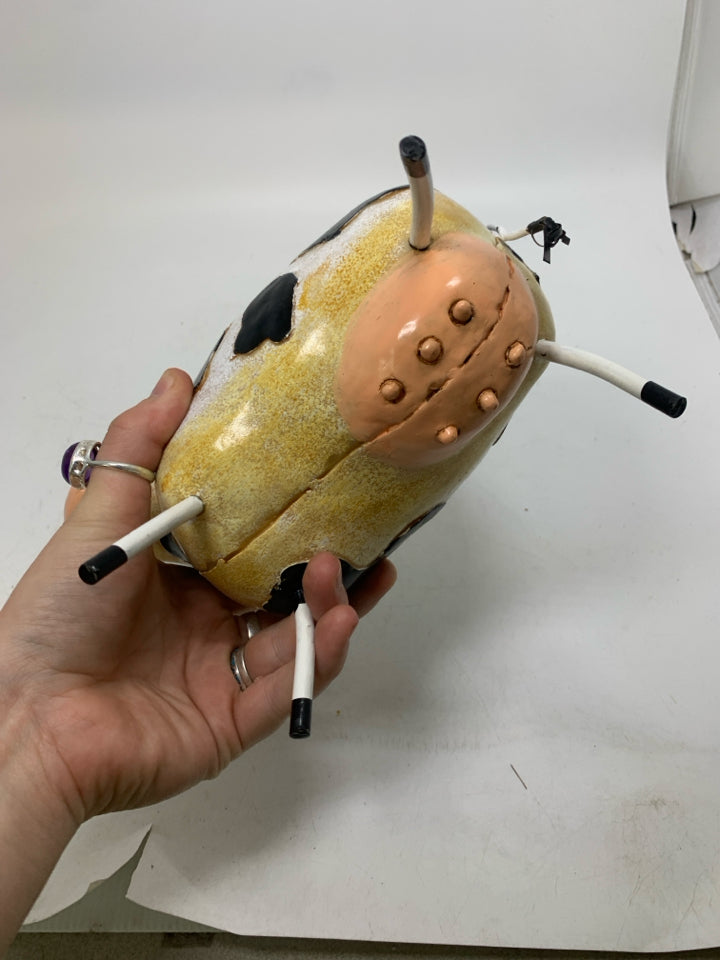 RESIN COW W/ METAL ACCENTS.